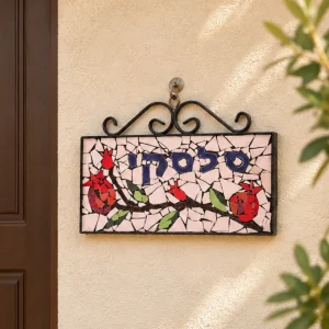 שלט פסיפס "סלסקי" עם רימונים, על הקיר ליד דלת הכניסה